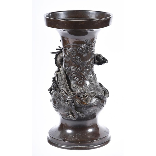 174 - A Japanese bronze vase cast with a dragon amongst clouds, the base inscribed with a four character m... 