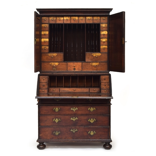 569 - A George II oak bureau bookcase estate cupboard, moulded pediment over two fielded panel doors, open... 