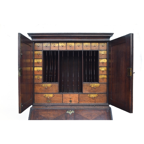 569 - A George II oak bureau bookcase estate cupboard, moulded pediment over two fielded panel doors, open... 