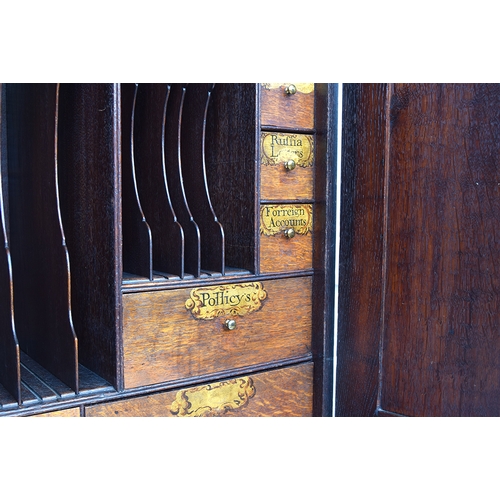 569 - A George II oak bureau bookcase estate cupboard, moulded pediment over two fielded panel doors, open... 