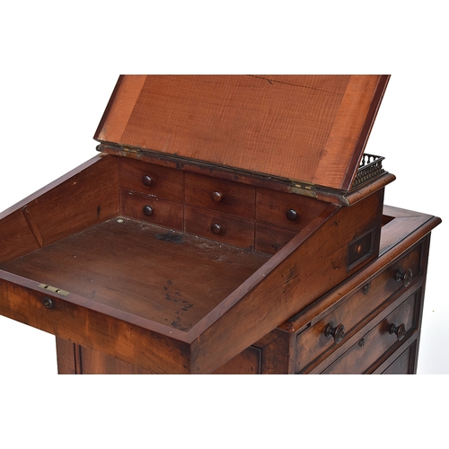 654 - A William IV mahogany Davenport desk, the sliding upper section with three quarter brass gallery and... 