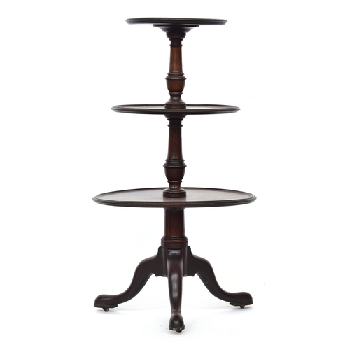 591 - A George III mahogany three-tier dumb-waiter, the three graduating dish tops on a turned column supp... 