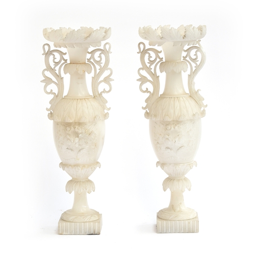 165 - A pair of intricately carved alabaster urns with scrolling foliate handles and floral spray design, ... 