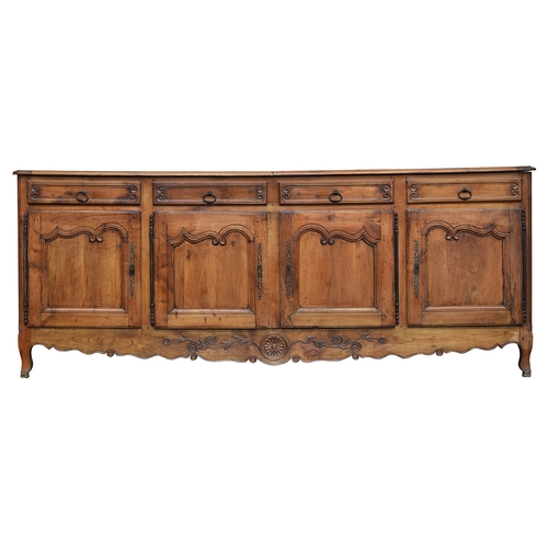 560 - A very large French walnut sideboard in 18th century style, having four drawers over four cupboard d... 