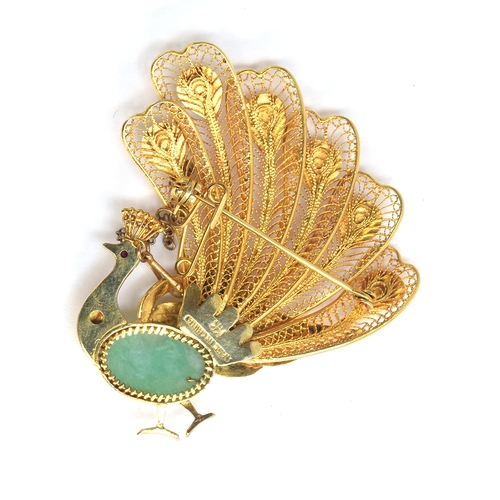 12 - A 20th century Chinese 14ct gold peacock brooch, set with jade cabochons and a ruby eye, with safety... 