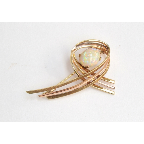 13 - A 14ct gold modernist brooch set with a large opal cabochon, approx. 7.4g, 5cm wide