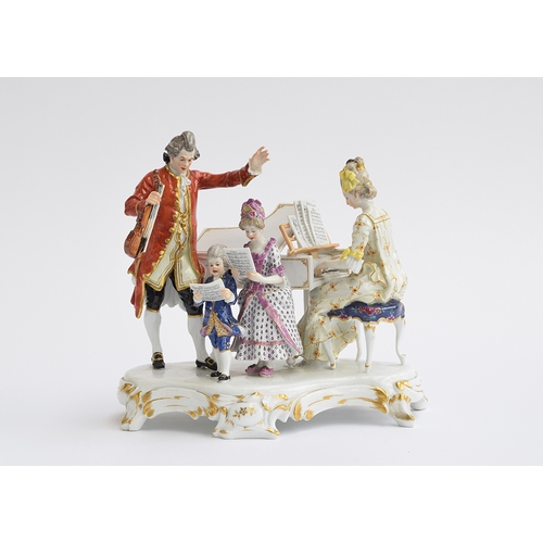 214 - A Meissen figure group of musicians, c.1900, Modelled as a lady playing a piano, before a gentleman ... 