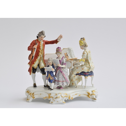 214 - A Meissen figure group of musicians, c.1900, Modelled as a lady playing a piano, before a gentleman ... 