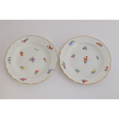 231 - A pair of early 20th century Meissen side plates, with hand painted floral decoration, heightened in... 