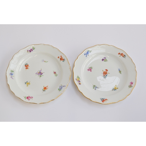 231 - A pair of early 20th century Meissen side plates, with hand painted floral decoration, heightened in... 