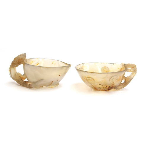 175 - Two Chinese translucent agate libation cups, each with handle in the form of a climbing tiger, the s... 