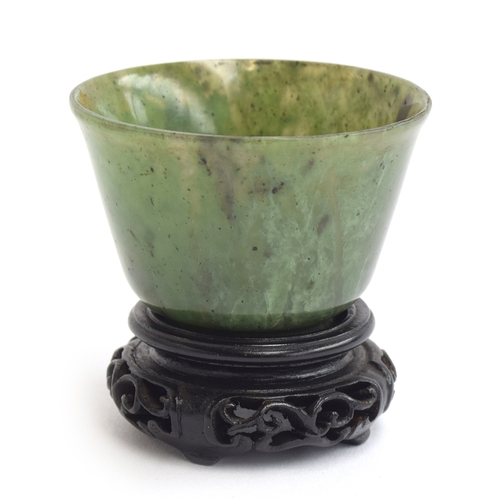 176 - A Chinese spinach jade cup, of flaring form with short form foot, approx. 6cm diameter, 4cm high