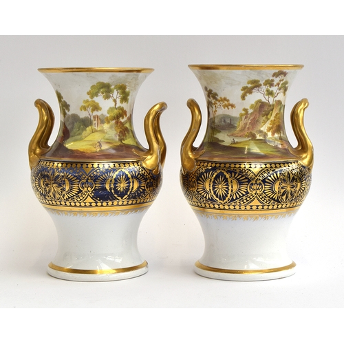 240 - A pair of twin handled porcelain urns hand painted with figures within Romantic landscapes, heighten... 