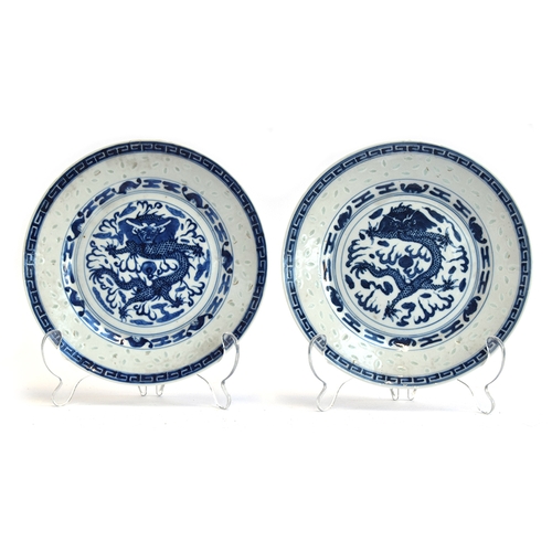 200 - A matched pair of Chinese translucent ware rice grain plates depicting dragons, four character Kangx... 