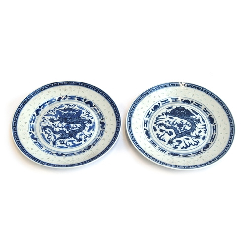 200 - A matched pair of Chinese translucent ware rice grain plates depicting dragons, four character Kangx... 