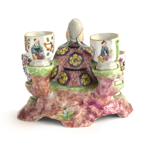 186 - A 19th century porcelain chinoiserie figural inkwell in the form of a seated sage surrounded by six ... 