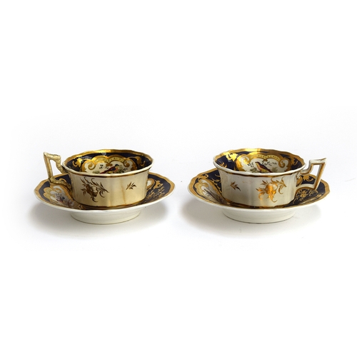 225 - A pair of 19th century Grainger teacups and saucers c.1830, Royal Flute shape, panels of floral spra... 