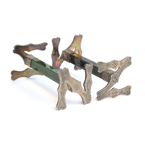 90 - An unusual pair of sterling silver mounted pounamu knife rests, the ends forming initials 'NZ with c... 