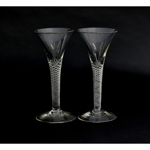 253 - A pair of Georgian air twist wine glasses, c.1760, multi-spiral stems with folded foot, 17cm high