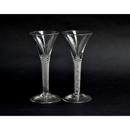 253 - A pair of Georgian air twist wine glasses, c.1760, multi-spiral stems with folded foot, 17cm high