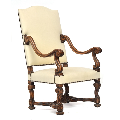 694 - A Continental throne chair, upholstered back and seat, with generous scrolling arms, on carved scrol... 