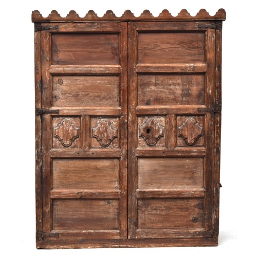 557 - An Indian cabinet, two panelled doors, converted with a hanging rail, 111cm wide, 50cm deep, 139cm h... 