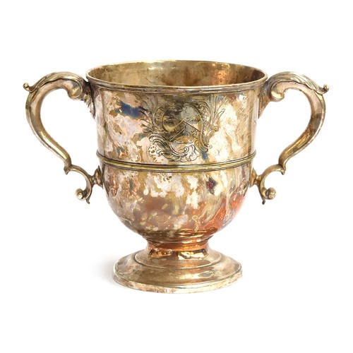 114 - A large silver trophy cup, twin acanthus capped handles, engraved with a crest, on spreading circula... 
