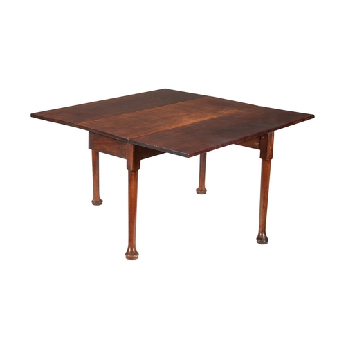 598 - A George II mahogany drop leaf table, circa 1750, the drop leaf top above turned supports and 
pad f... 