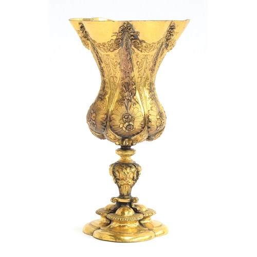 142 - A late 19th century Italian gilt copper chalice, with floral swag pattern with trefoil form foot, 19... 