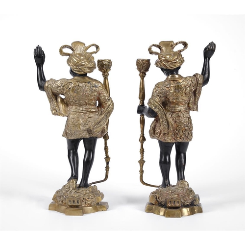 146 - A pair of brass and patinated models of 'Blackamoors', early 20th century, as candlesticks, 39cm hig... 