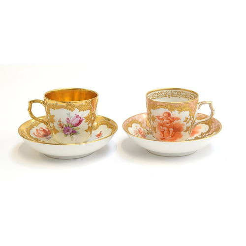 229 - Two early 20th century KPM porcelain cups and saucers, one with floral spray design and gilt interio...