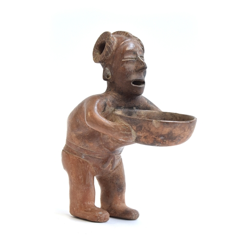 171 - A Pre-Colombian pottery figural vessel in the form of a man holding a dish, 27cm high

Provenance: p... 