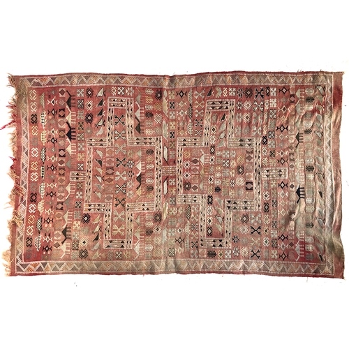 723 - A red ground Berber rug with camel and bird motifs, 150x250cm