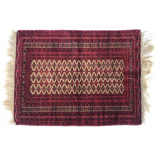 726 - A small red ground tekke style rug, 107x142cm