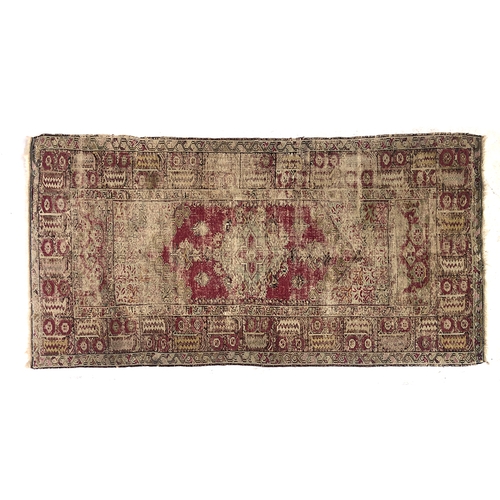 730 - A worn Turkish rug, 122x234cm