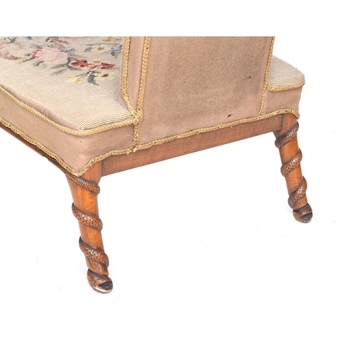 702 - A small high backed tapestry chair with serpentine carving to the back legs