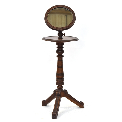 651 - A late Victorian shaving stand, the adjustable circular mirror over a circular shelf, on a turned co... 