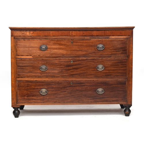 586 - A French mahogany and cross banded commode chest of three drawers, c.1800, the frieze with secret dr... 