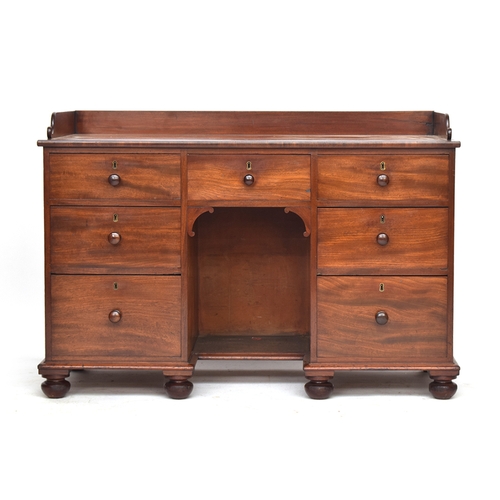 652 - A 19th century mahogany kneehole dressing table, three quarter gallery, single drawer over kneehole,... 