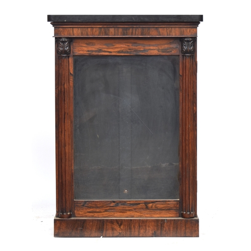 617 - A Regency rosewood pier cabinet, the marble top over glazed door, flanked by lotus capped fluted hal... 