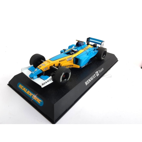 127 - An SCX McLaren F1 car, boxed, together with a Scalextric Renault F1 car, boxed