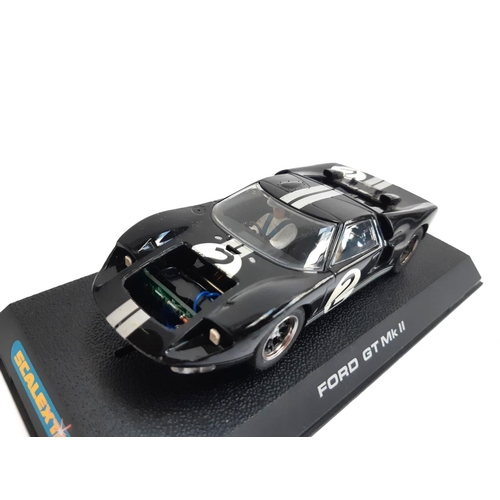 128 - A Scalextric Ford GT Mk II, boxed, together with 2 2000 Cadillac LMP, both unboxed, and a Nissan 350... 