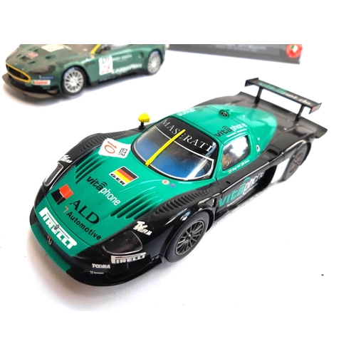 129 - An SCX Aston Martin DBR-9, together with a Ninco Mercedes CLK, a Carrera Evolution Maserati and an e... 