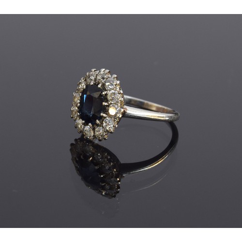 39 - An early 20th century platinum, sapphire and diamond cluster ring, the central mixed cut sapphire 8.... 
