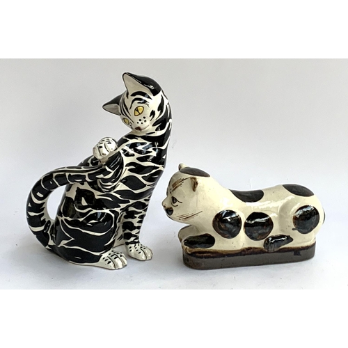 80 - A black and white Italian majolica cat, 26cm high; together with one other, 22cm long