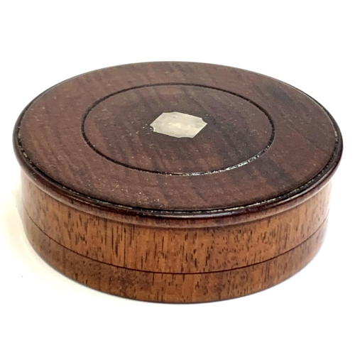 114 - A fruitwood turned treen cylindrical box, the lid inset with white metal plaque, 10.3cmD, 3.2cmH