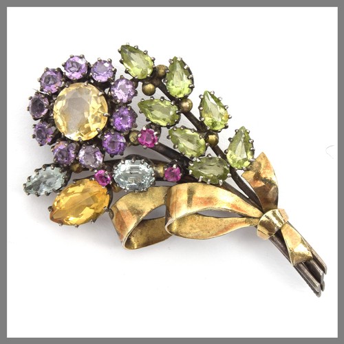 Attributed to Dorrie Nossiter, a c.1930 Arts and Crafts gem set floral brooch, set with citrines, amethysts, aquamarines, peridots and rubies, 6cm long, 18.5g