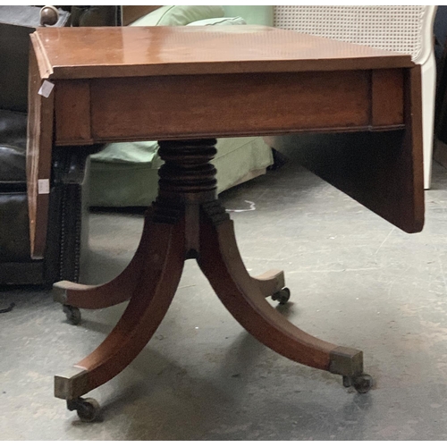 694 - A Regency mahogany Pembroke table, on turned column, with swept legs and brass caps and casters, 114... 