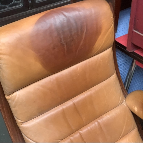 640 - A Danish leather reclining swivel chair, in need of restoration