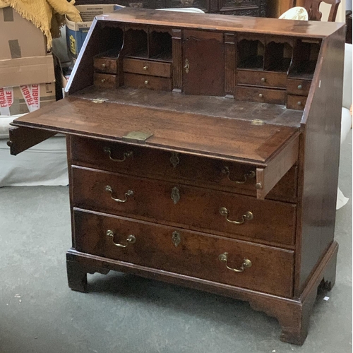 700 - A George III oak bureau, fall front opening to a fitted interior, over four graduated drawers, on br... 